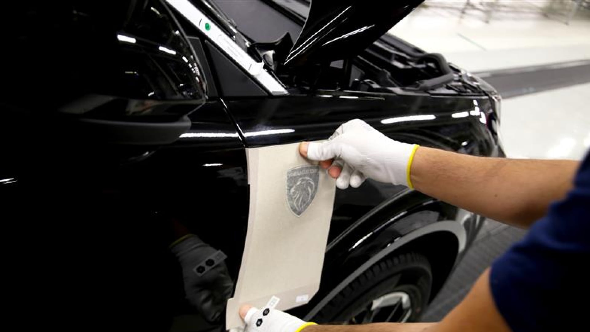 Mechanic working on a Peugeot vehicle